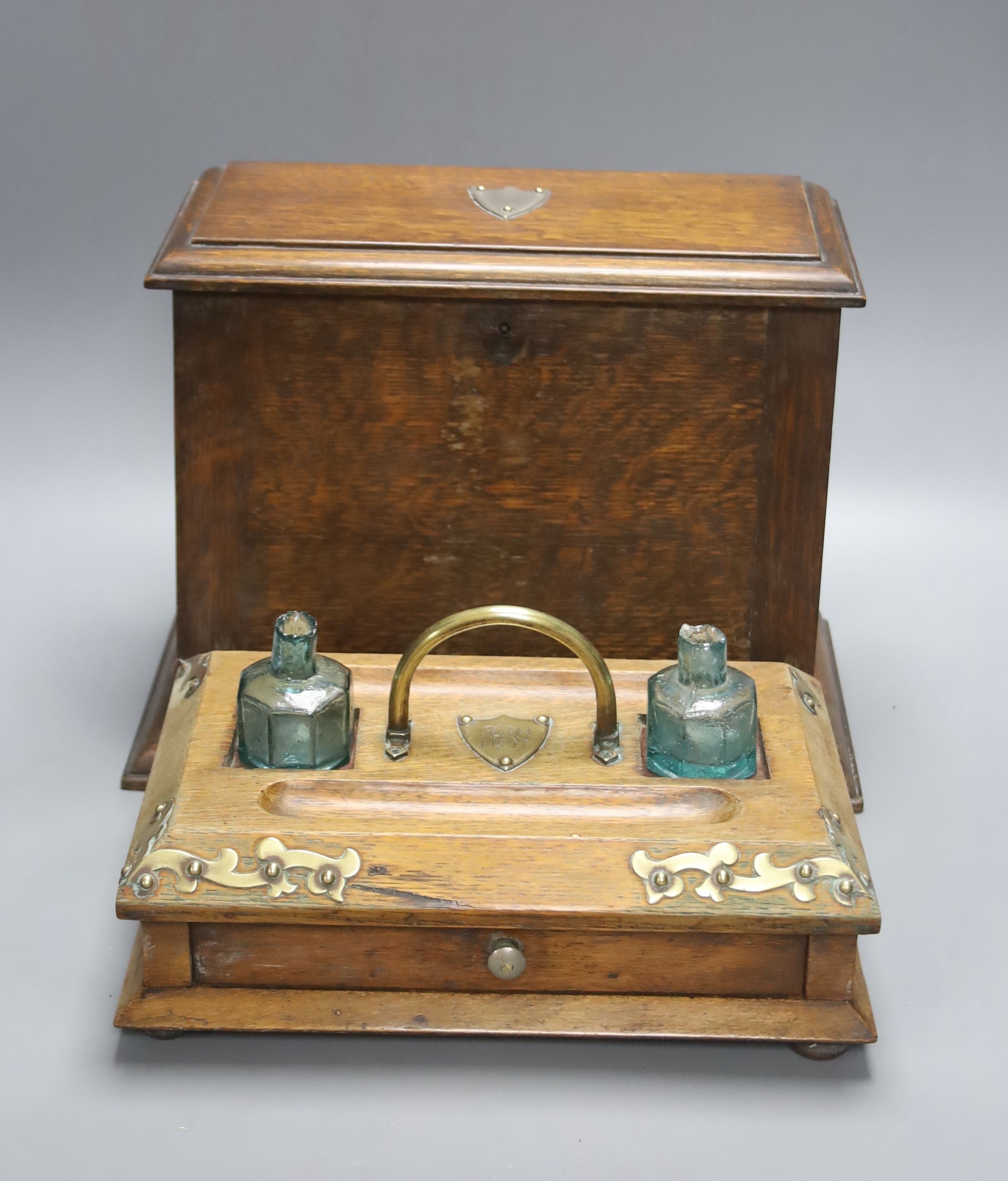 An Edwardian oak stationery box and an oak inkstand